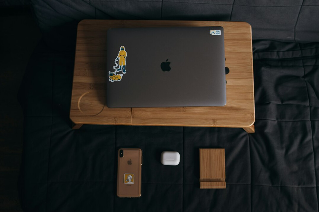Laptop with strategy documents on a desk